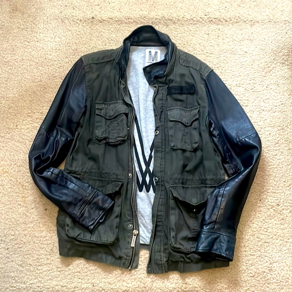 Light weight jacket with leather sleeves.